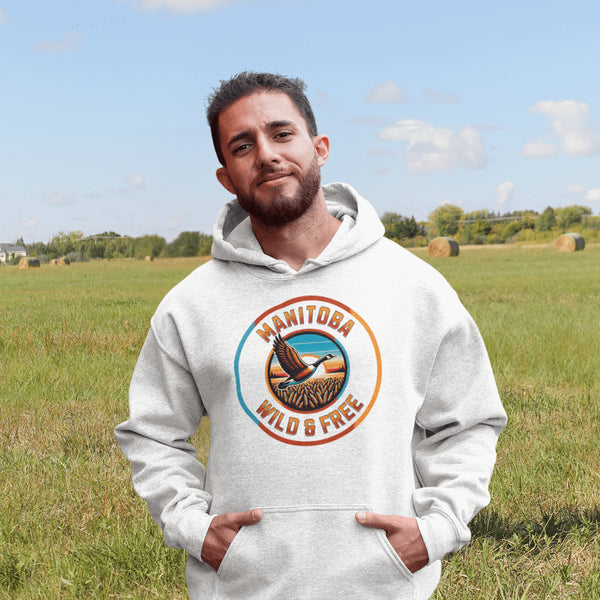 Celebrate the heart of the prairies with our Manitoba – Wild & Free hoodie, featuring a stunning graphic of a Canadian goose soaring over golden wheat fields.
